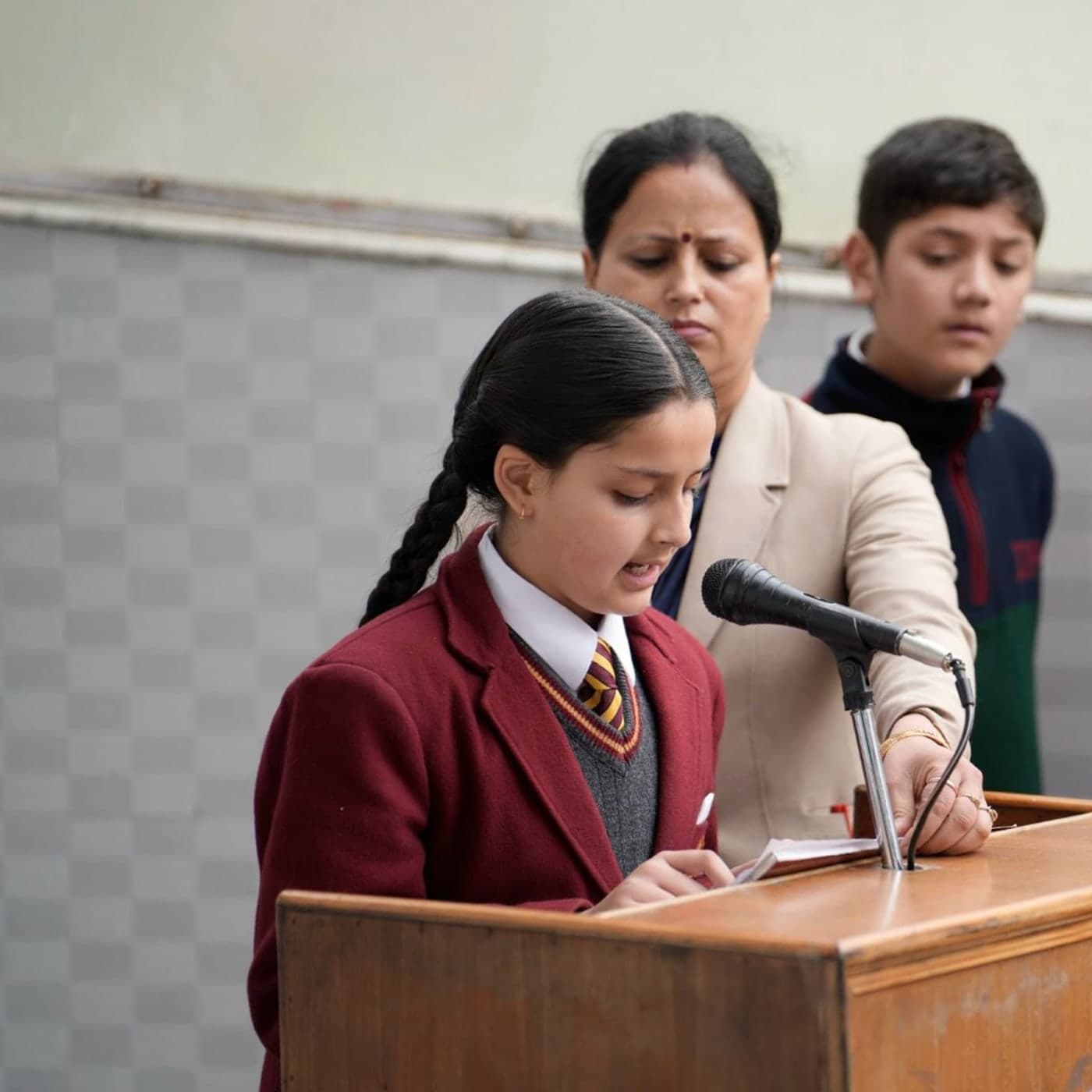 A Dalhousie student reading at the microphone in assembly
