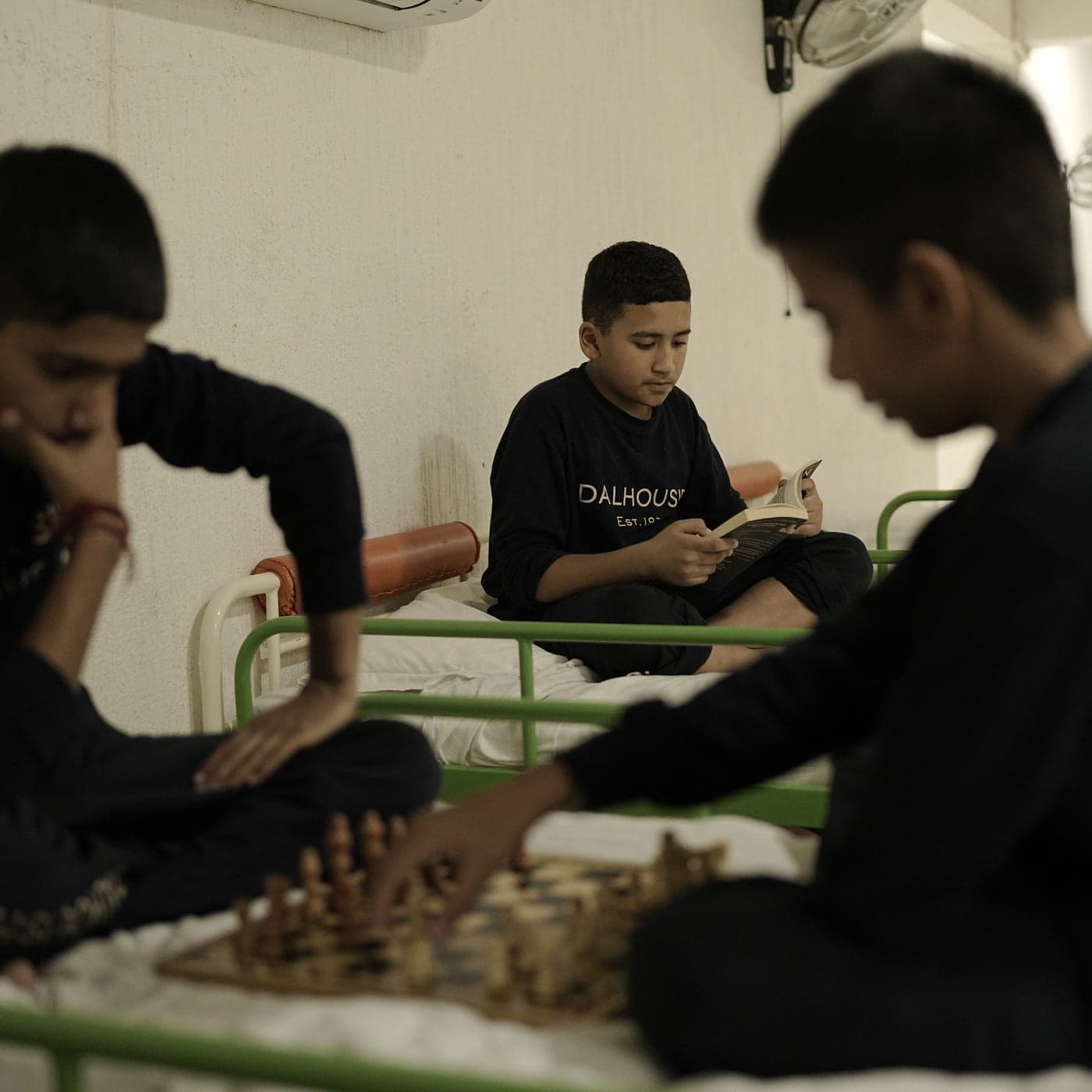 Boarders reading and playing chess in a Dalhousie dormitory