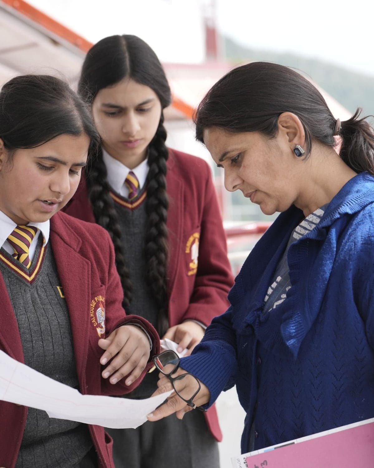 A teacher going through a student's paper with her