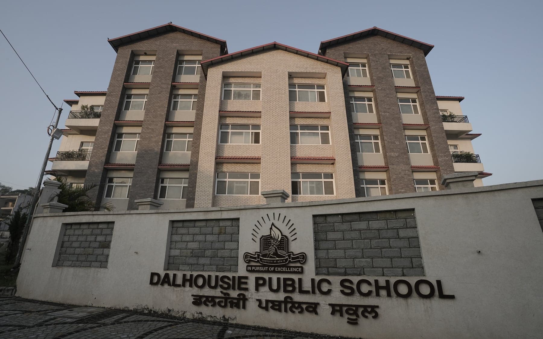The New Chandigarh campus building behind the school sign