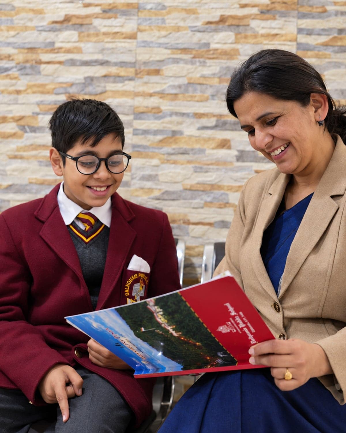 A mentor going through the school magazine with a student